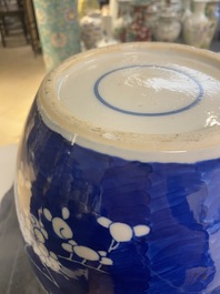 A pair of large Chinese blue and white 'prunus' jars and covers, 19th C.